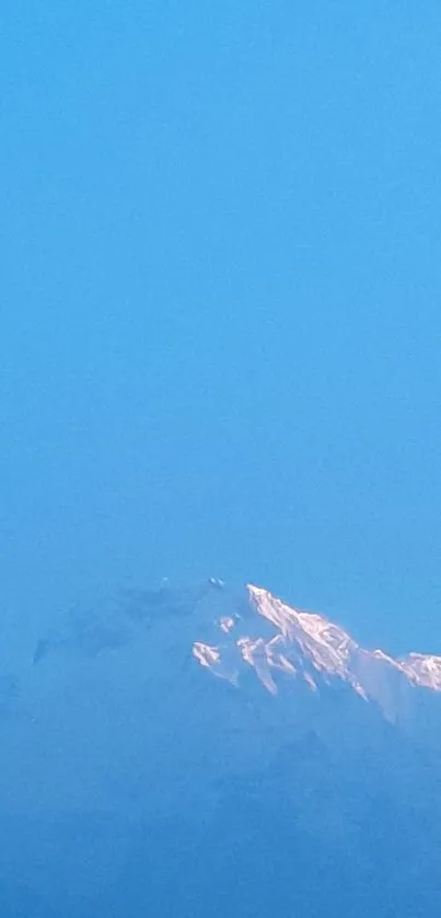 Serene snowy mountain under a clear blue sky.