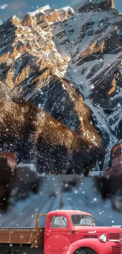 Vintage red truck in snowy mountain scene with town backdrop.