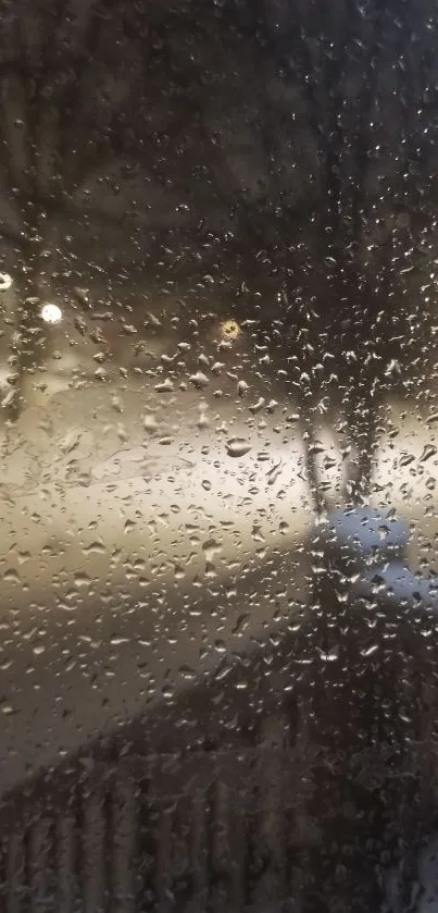 Snowy night view with raindrops on window