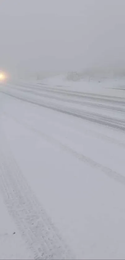 Snowy road in winter with misty atmosphere.