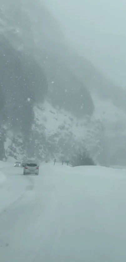 Car driving on a snowy mountain road during winter.