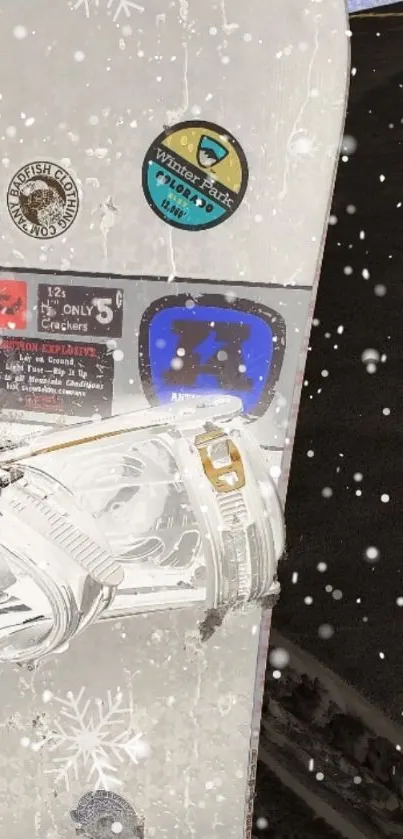 Close-up of a snowboard with snowy details and winter stickers.