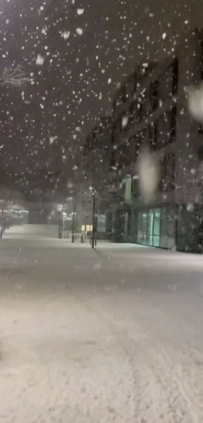 Snowy night street scene with glowing streetlights.