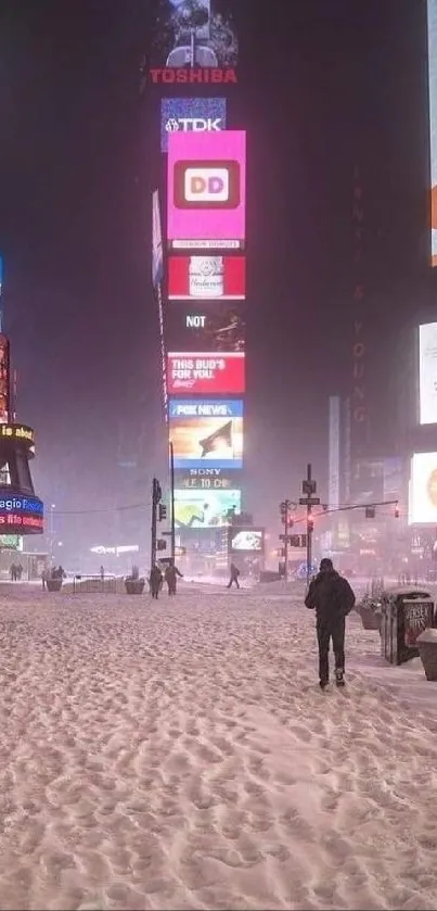 Snow-covered Times Square street at night.