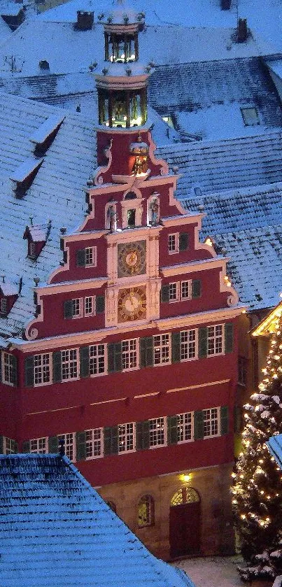 Snow-covered European town rooftop at dusk with festive lights.