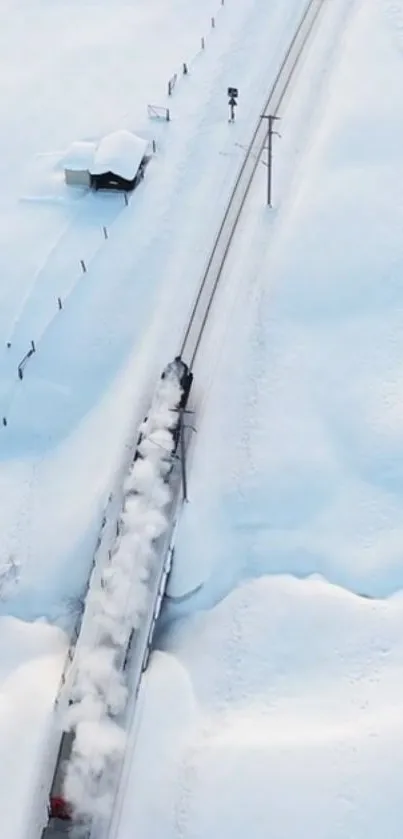 Aerial view of a train traveling through a snowy landscape.