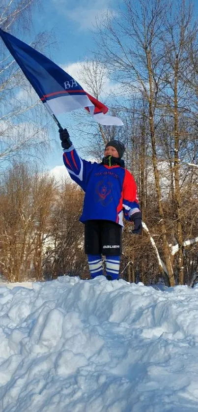 Person holding flag on snowy mound under a blue sky.