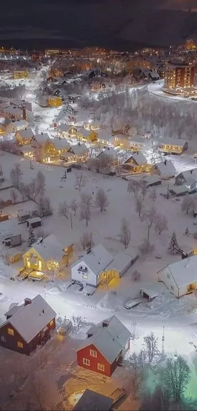 Aerial nighttime view of snowy town with glowing lights.