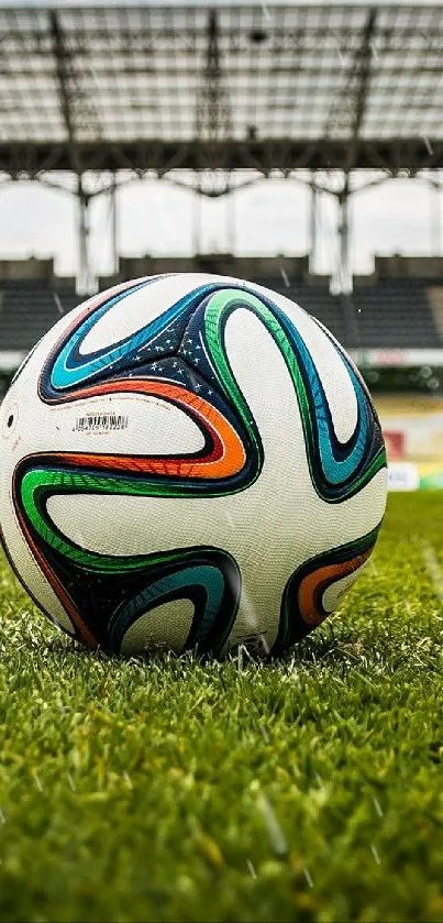 Soccer ball on stadium field with green grass.