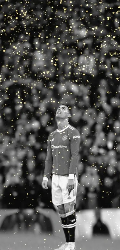 Soccer player in black and white with gold sparkles background.