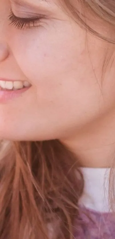 Close-up of a smiling person with light brown hair.