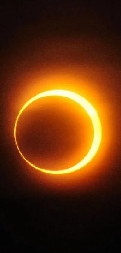 Orange solar eclipse ring against a dark background.