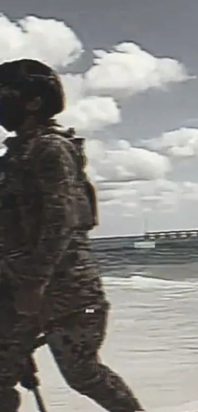 A soldier in camouflage walks along a beach under a cloudy sky.