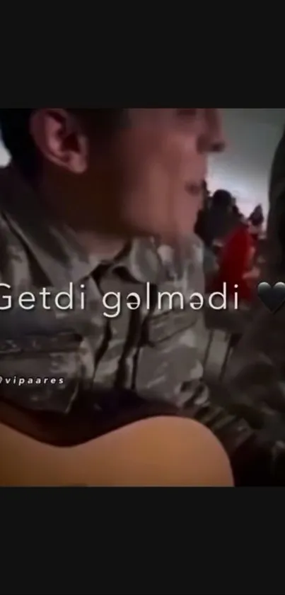 Soldier playing guitar with heartfelt text overlay in a dim setting.