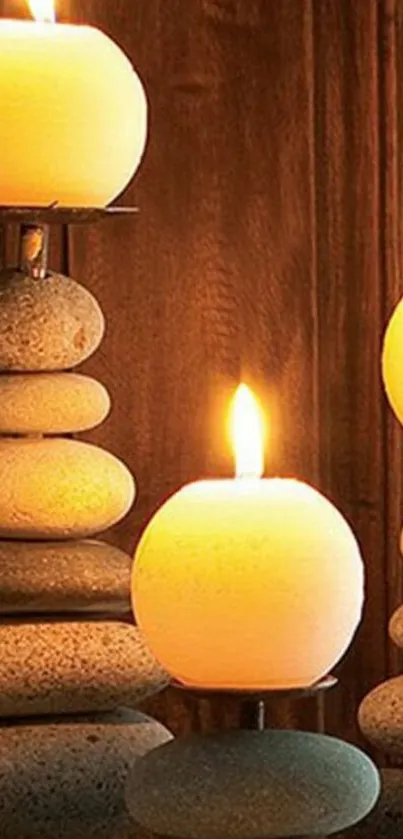 Serene mobile wallpaper with candlelight and stacked stones.