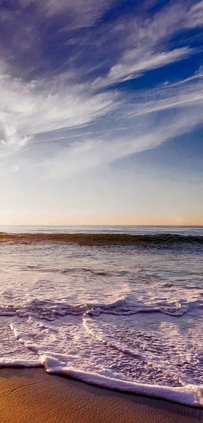 Sunset over the ocean with waves on the beach.