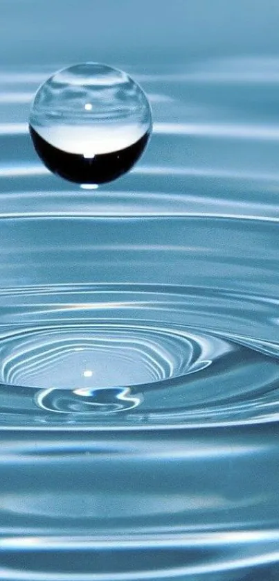 Water droplet creating ripples on blue surface, capturing a serene moment.