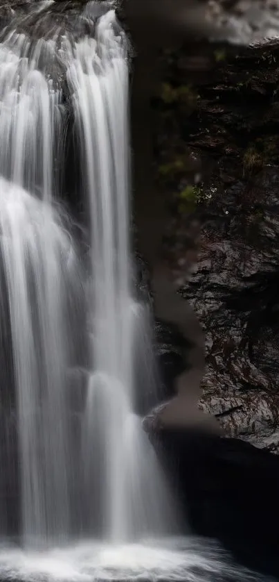 Serene waterfall cascading over rocky cliffs.