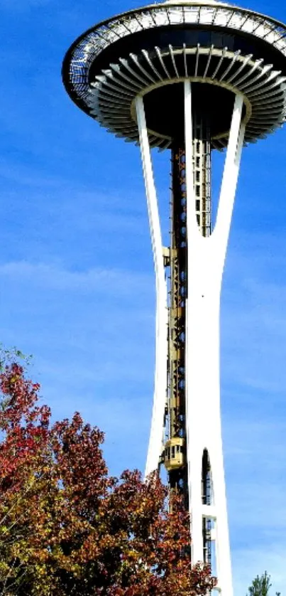 Space Needle with blue sky and autumn trees.