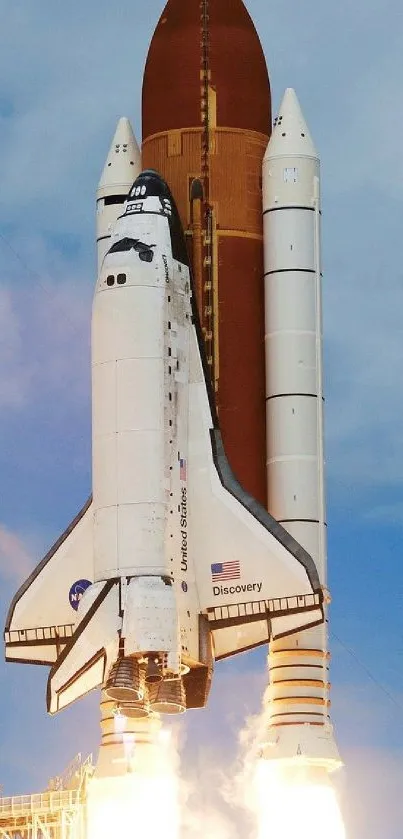 Space shuttle launching into blue sky with rockets igniting beneath.