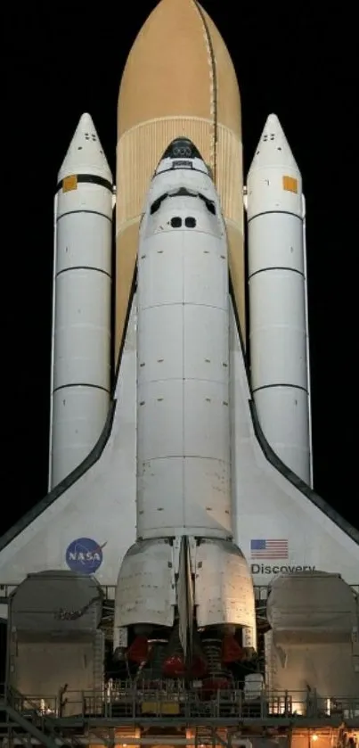 Space shuttle ready for launch at night.