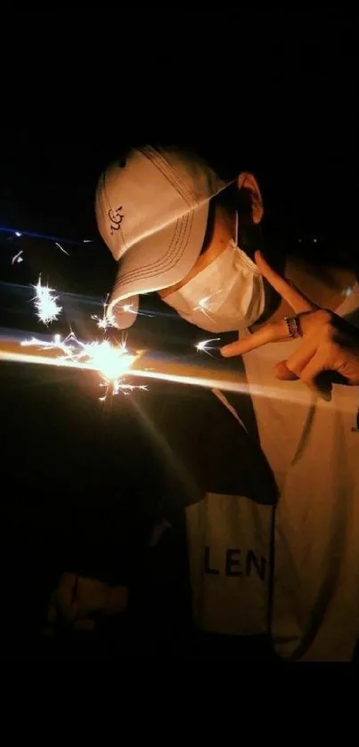 A person holds a sparkler at night, capturing glowing light against a dark background.