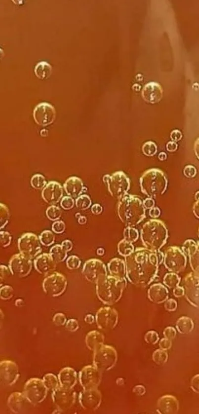 A close-up of shimmering bubbles in amber liquid, offering a sleek mobile wallpaper.