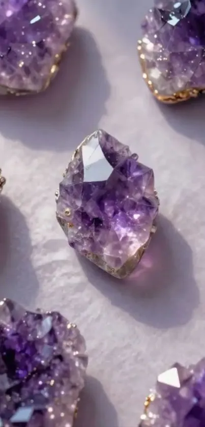 Collection of sparkling amethyst gemstones on a light surface.