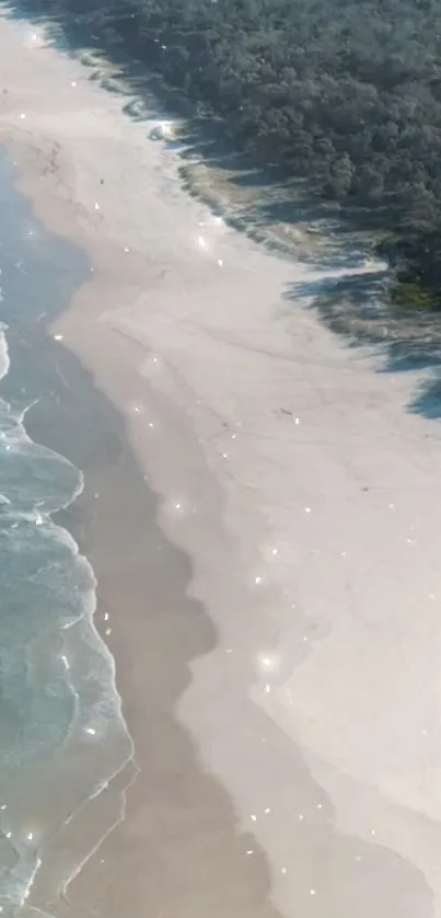 Aerial view of a sparkling beach with sunlit waves and sandy shores.