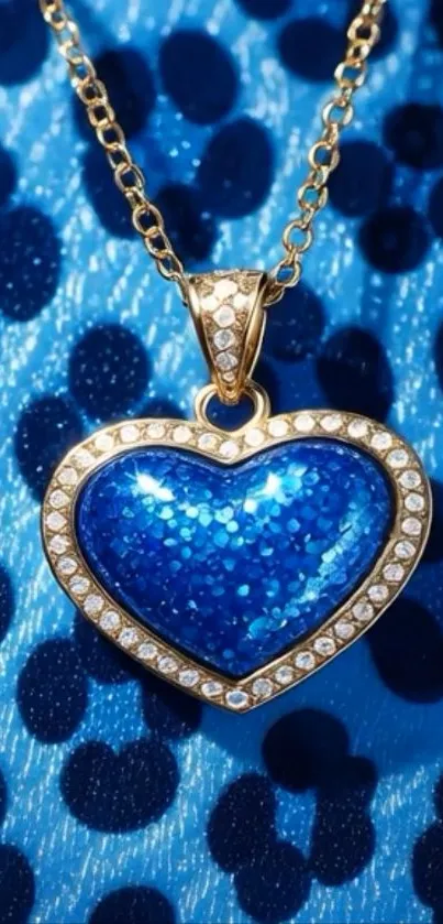 Blue heart pendant with gold chain on a textured background.