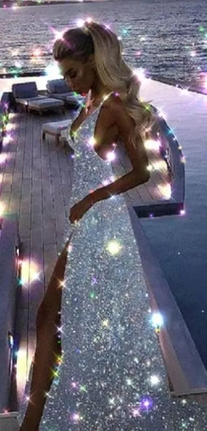 Elegant woman in sparkling dress by the ocean at night.