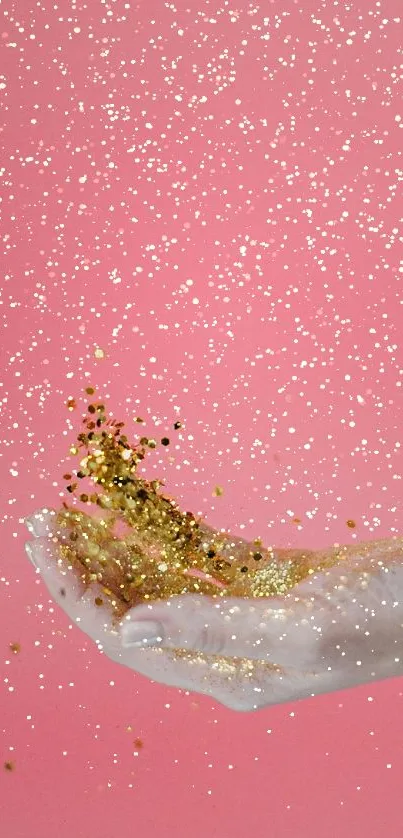 A hand tossing gold glitter on a pink background wallpaper.