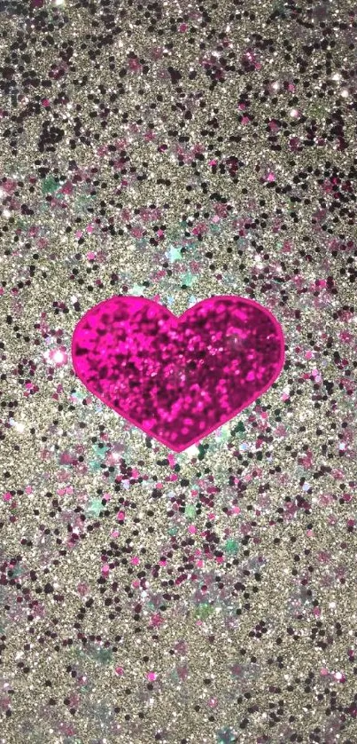 Vibrant pink heart on silver glitter background.
