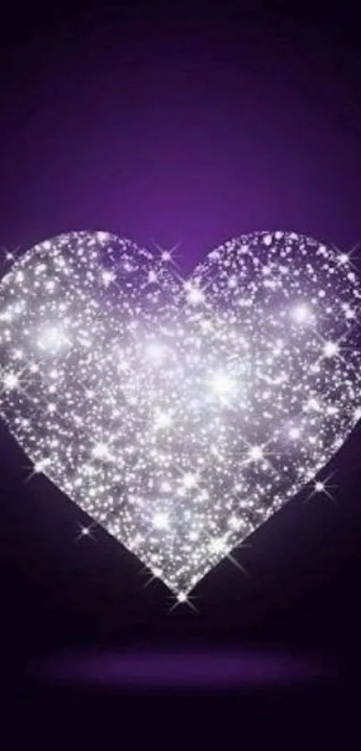 Sparkling purple heart with glittering effect on dark background.