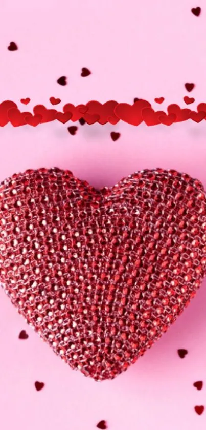 Red glitter heart on pink background with scattered small hearts.