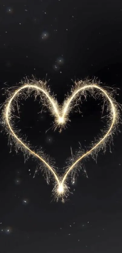 Heart-shaped sparkler on a black background, creating a romantic, glowing effect.