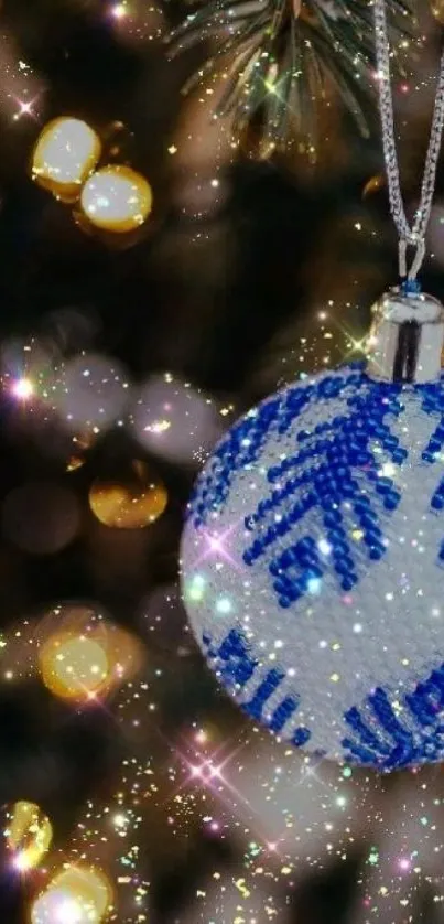 Blue and white Christmas ornament on tree with sparkling lights.