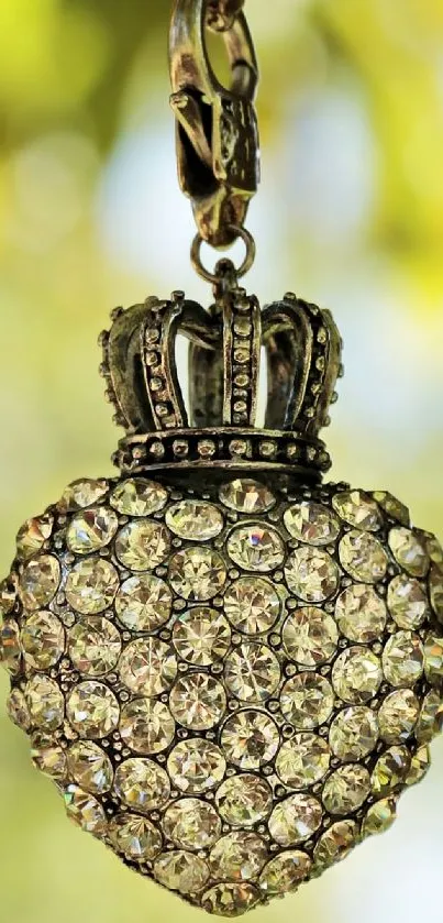 A jeweled heart pendant with a crown on a blurred background.