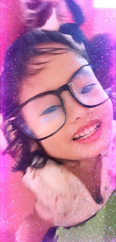 Smiling girl with glasses and pink sparkles background.