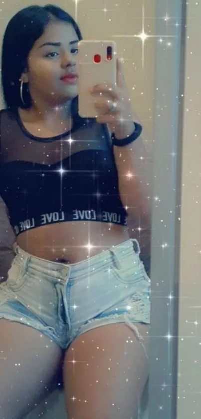 Woman takes fashionable mirror selfie with sparkling star effects.