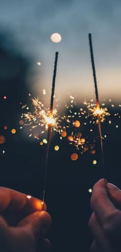 Hands holding sparklers at night with glowing sparks.