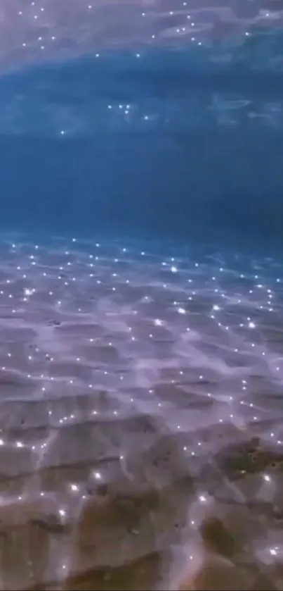 Sparkling ocean floor with shimmering light beneath water.