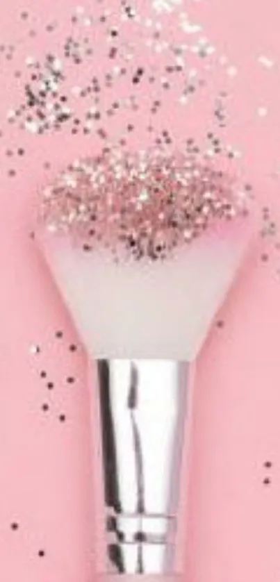 A pink brush with glitter on a pink background.