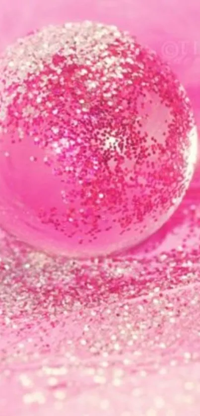 Sparkling pink globe with glitter accents on vibrant background.