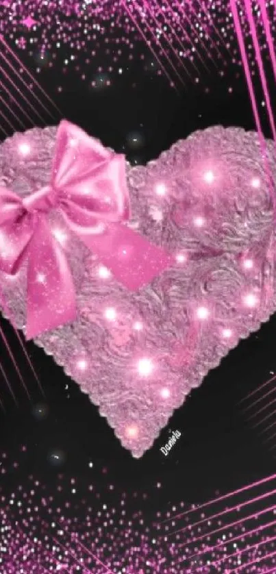 Pink heart with sparkles and ribbon on black background.