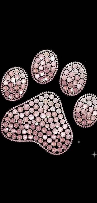 Sparkling pink jeweled paw on black background.