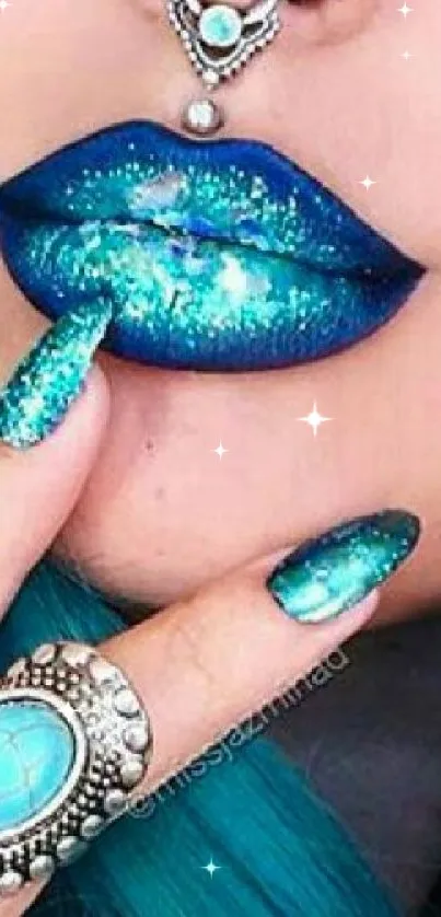 Close-up of glittering teal lips with matching nails and jewelry.