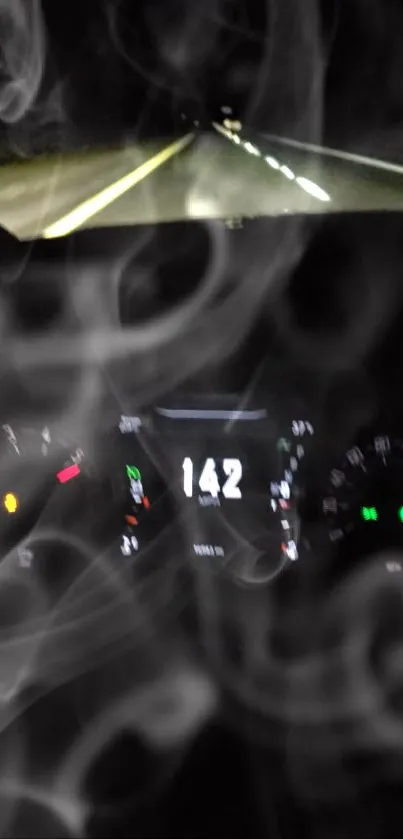 Car speedometer with smoke in nighttime road setting.