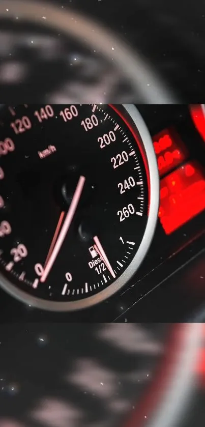 Close-up of car speedometer and RPM gauge with red accents.