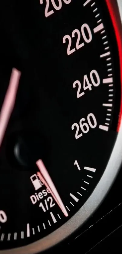 Close-up of a car speedometer with black and red features.